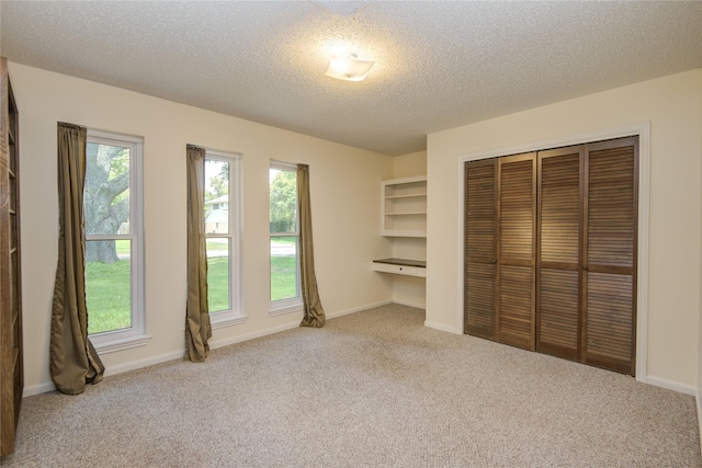 55 Flag Ct, Lake Jackson, TX 77566 - unfurnished bedroom with carpet, a closet, a textured ceiling, and baseboards