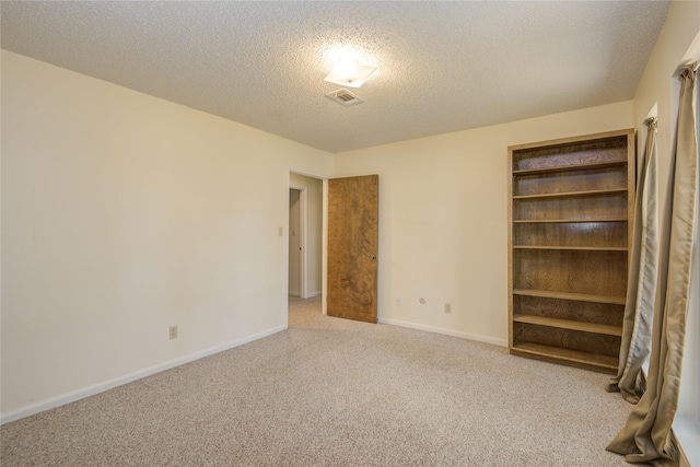 55 Flag Ct, Lake Jackson, TX 77566 - spare room featuring carpet, a textured ceiling, and baseboards