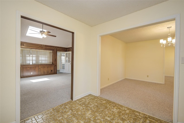 55 Flag Ct, Lake Jackson, TX 77566 - empty room featuring carpet, a chandelier, a ceiling fan, baseboards, and a textured ceiling