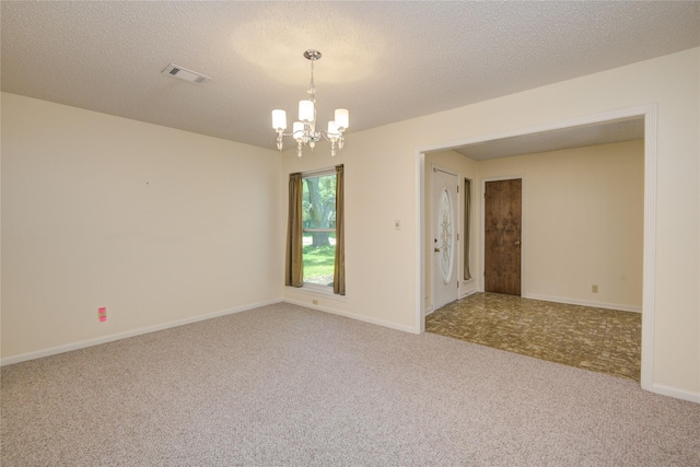 55 Flag Ct, Lake Jackson, TX 77566 - spare room featuring a chandelier, carpet, a textured ceiling, and baseboards