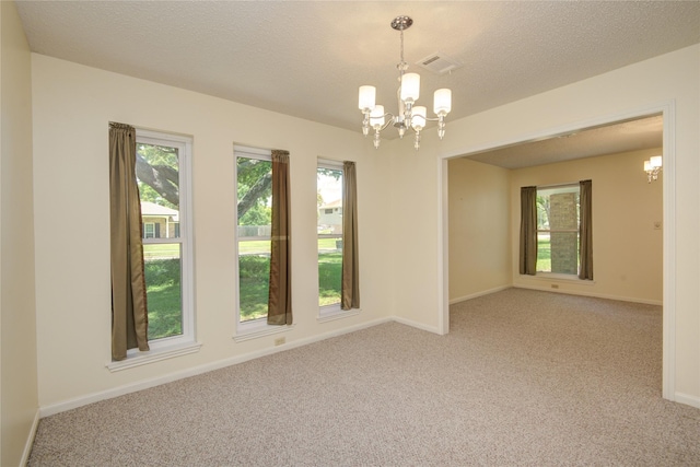 55 Flag Ct, Lake Jackson, TX 77566 - unfurnished room featuring a chandelier, light carpet, baseboards, and a textured ceiling