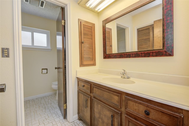 55 Flag Ct, Lake Jackson, TX 77566 - bathroom with vanity, toilet, and baseboards