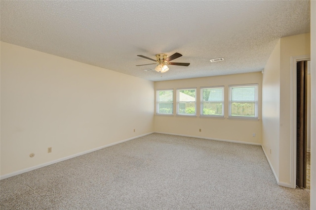 55 Flag Ct, Lake Jackson, TX 77566 - spare room featuring a ceiling fan, light colored carpet, a textured ceiling, and baseboards
