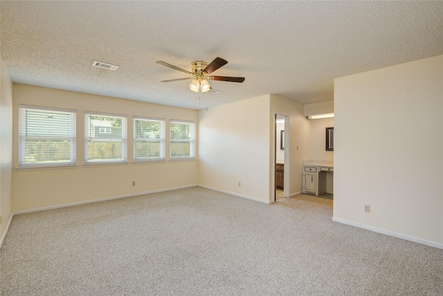 55 Flag Ct, Lake Jackson, TX 77566 - unfurnished room featuring a ceiling fan, light colored carpet, a textured ceiling, and baseboards