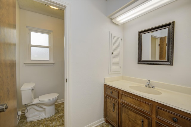 55 Flag Ct, Lake Jackson, TX 77566 - bathroom featuring toilet, vanity, and baseboards