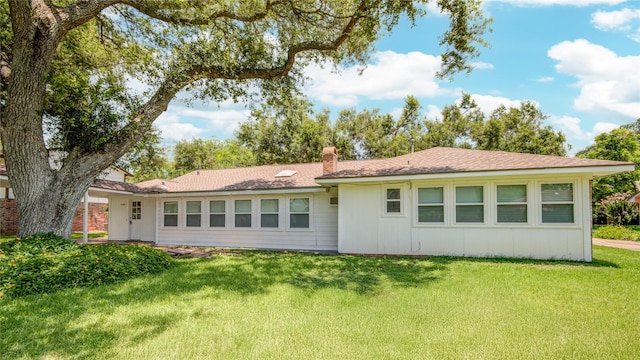55 Flag Ct, Lake Jackson, TX 77566 - back of property with a chimney and a lawn