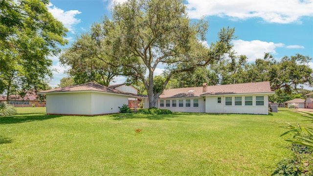 55 Flag Ct, Lake Jackson, TX 77566 - rear view of property featuring a lawn and a chimney