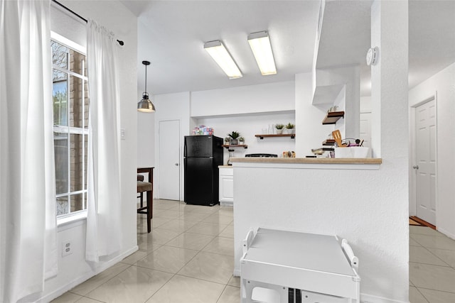 2011 Spenwick Dr Unit 415, Houston, TX 77055 - kitchen with freestanding refrigerator, light countertops, healthy amount of natural light, and light tile patterned floors
