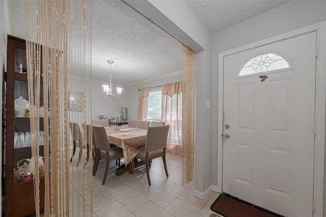 10534 Towne Square Rd, Sugar Land, TX 77498 - dining area with a textured ceiling, a chandelier, light tile patterned floors, and crown molding