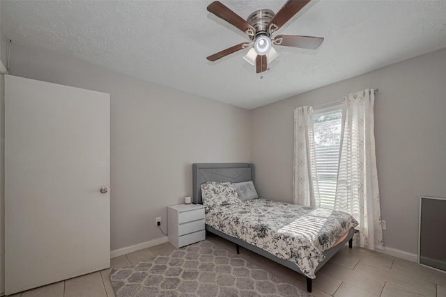 10534 Towne Square Rd, Sugar Land, TX 77498 - tiled bedroom featuring baseboards, a ceiling fan, and a textured ceiling