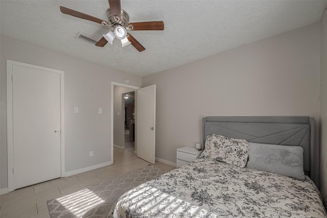 10534 Towne Square Rd, Sugar Land, TX 77498 - bedroom featuring light tile patterned floors, baseboards, a textured ceiling, and ceiling fan