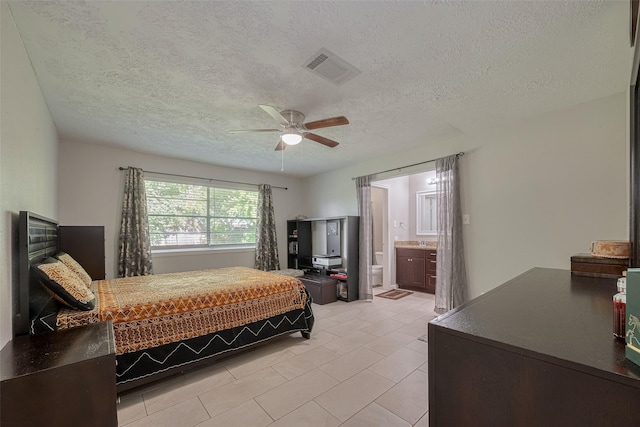 10534 Towne Square Rd, Sugar Land, TX 77498 - bedroom with a textured ceiling, light tile patterned floors, a ceiling fan, and connected bathroom
