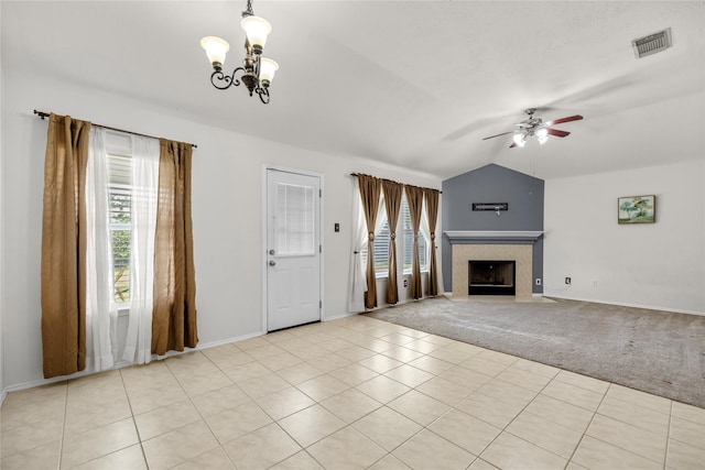 18206 Eton Ridge Ct, Richmond, TX 77407 - unfurnished living room with vaulted ceiling, a ceiling fan, a chandelier, a tiled fireplace, and baseboards