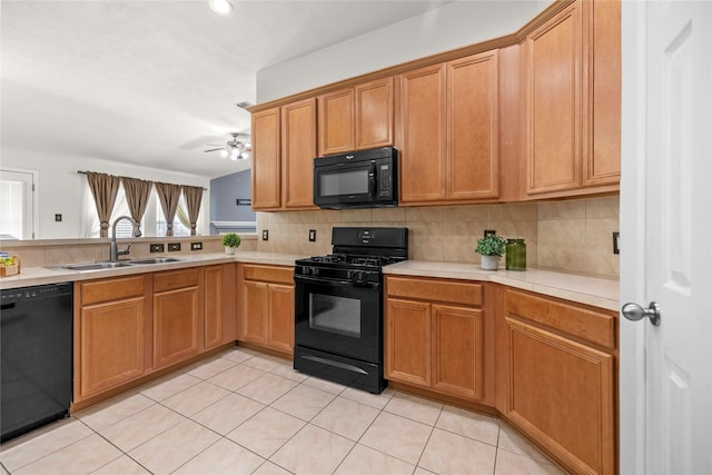 18206 Eton Ridge Ct, Richmond, TX 77407 - kitchen with black appliances, a sink, light countertops, tasteful backsplash, and light tile patterned floors
