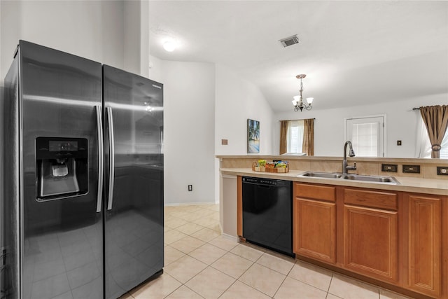 18206 Eton Ridge Ct, Richmond, TX 77407 - kitchen with stainless steel fridge with ice dispenser, dishwasher, a sink, brown cabinets, and a chandelier