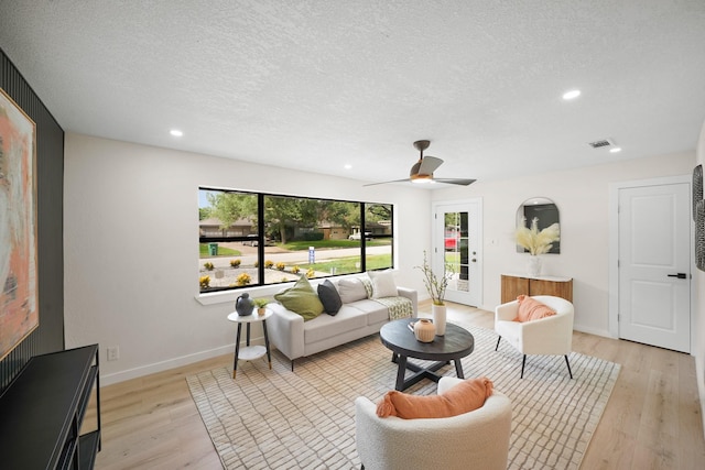 4813 Hummingbird St, Houston, TX 77035 - living room featuring a textured ceiling, light wood-type flooring, ceiling fan, and recessed lighting