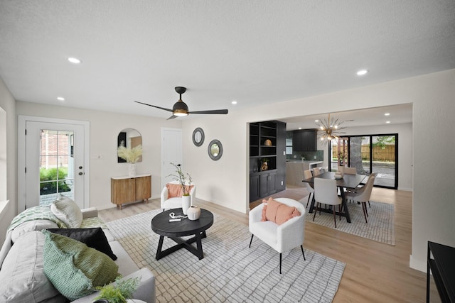 4813 Hummingbird St, Houston, TX 77035 - living area featuring light wood finished floors, recessed lighting, a chandelier, and ceiling fan