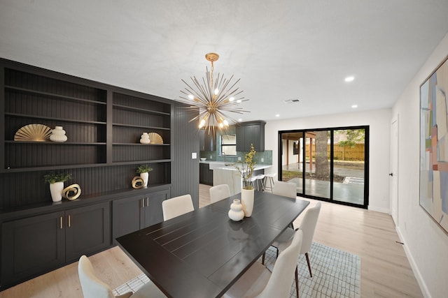 4813 Hummingbird St, Houston, TX 77035 - dining room with a chandelier, light wood-style flooring, recessed lighting, and built in shelves