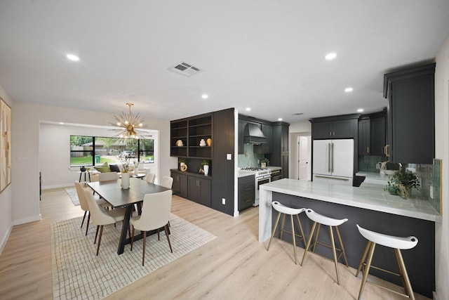 4813 Hummingbird St, Houston, TX 77035 - dining space with light wood-style flooring, recessed lighting, and a chandelier