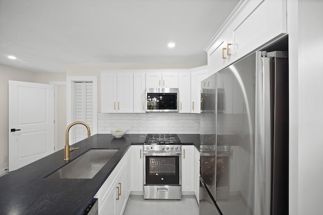 4813 Hummingbird St, Houston, TX 77035 - kitchen featuring stainless steel appliances, dark countertops, tasteful backsplash, white cabinets, and recessed lighting