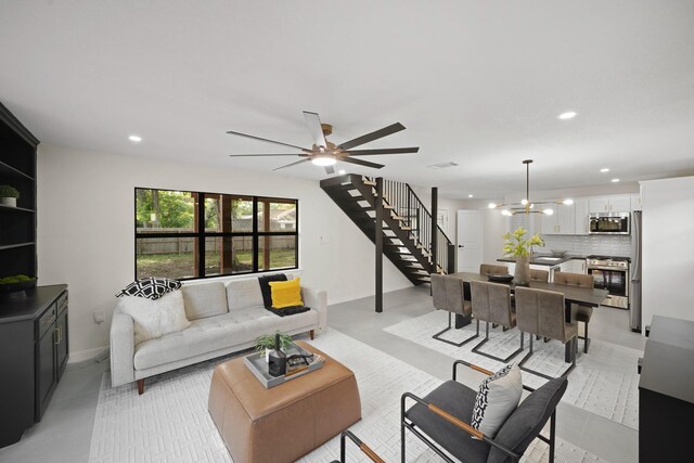 4813 Hummingbird St, Houston, TX 77035 - living room featuring stairs, recessed lighting, a chandelier, and a ceiling fan