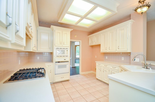 14403 Reissen Ln, Houston, TX 77069 - kitchen with white appliances, a sink, light tile patterned flooring, light countertops, and decorative backsplash