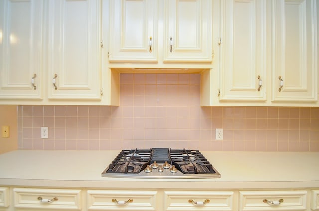 14403 Reissen Ln, Houston, TX 77069 - kitchen with stainless steel gas stovetop, light countertops, cream cabinets, and decorative backsplash