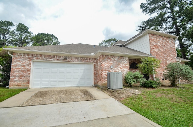 14403 Reissen Ln, Houston, TX 77069 - view of front of home featuring cooling unit, concrete driveway, brick siding, an attached garage, and a shingled roof
