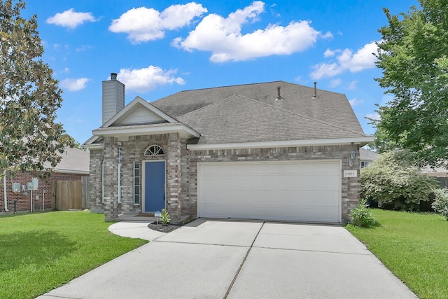 25819 Oakridge Forest Ln, Spring, TX 77386 - view of front facade featuring concrete driveway, an attached garage, a chimney, roof with shingles, and brick siding