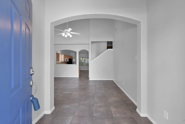 25819 Oakridge Forest Ln, Spring, TX 77386 - foyer with arched walkways, ceiling fan, and baseboards