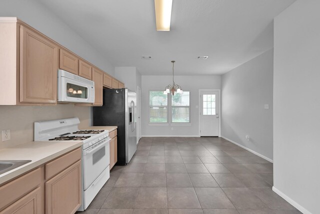 25819 Oakridge Forest Ln, Spring, TX 77386 - kitchen with white appliances, baseboards, a chandelier, and light countertops