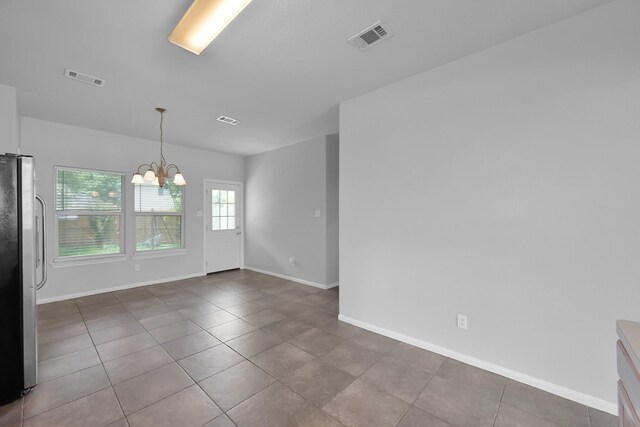 25819 Oakridge Forest Ln, Spring, TX 77386 - empty room with a chandelier, baseboards, and tile patterned flooring