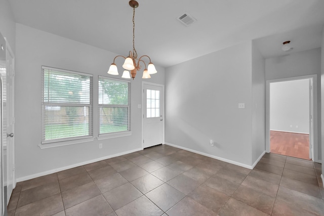25819 Oakridge Forest Ln, Spring, TX 77386 - unfurnished dining area featuring tile patterned floors, a chandelier, and baseboards