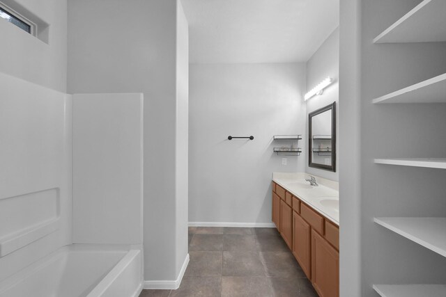 25819 Oakridge Forest Ln, Spring, TX 77386 - full bathroom with double vanity, baseboards, and tub / shower combination