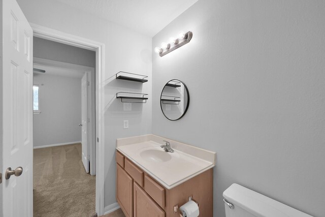 25819 Oakridge Forest Ln, Spring, TX 77386 - bathroom featuring vanity, toilet, and baseboards