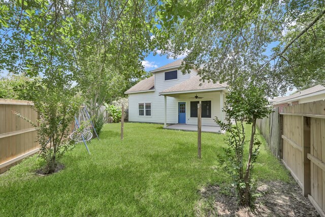 25819 Oakridge Forest Ln, Spring, TX 77386 - back of property featuring ceiling fan, roof with shingles, and a patio