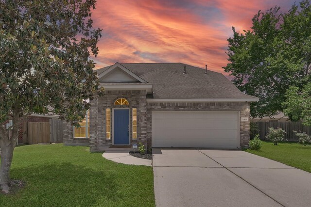 25819 Oakridge Forest Ln, Spring, TX 77386 - view of front of property with a garage, concrete driveway, a shingled roof, and stone siding