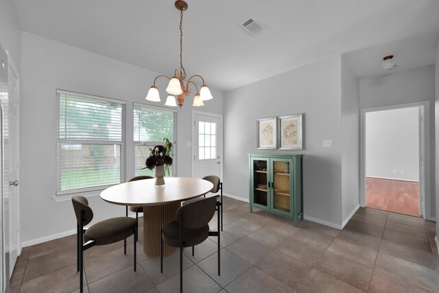 25819 Oakridge Forest Ln, Spring, TX 77386 - tiled dining space with a chandelier and baseboards
