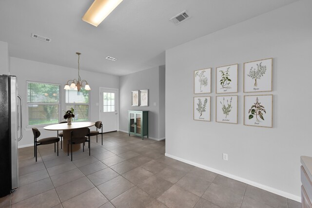 25819 Oakridge Forest Ln, Spring, TX 77386 - tiled dining space featuring a chandelier and baseboards