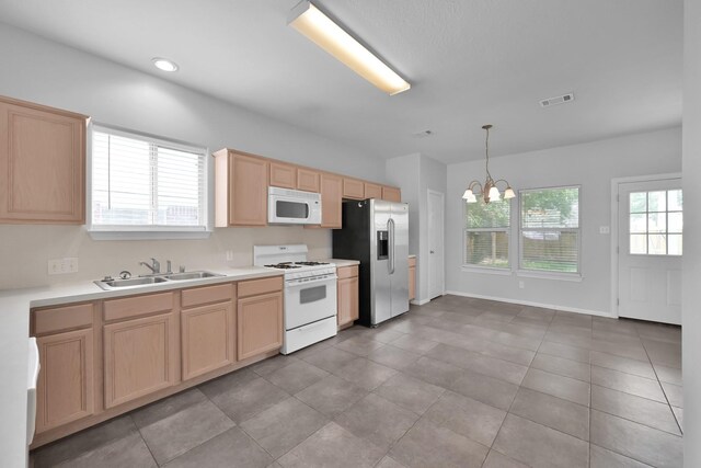 25819 Oakridge Forest Ln, Spring, TX 77386 - kitchen featuring white appliances, light brown cabinets, a sink, and a chandelier