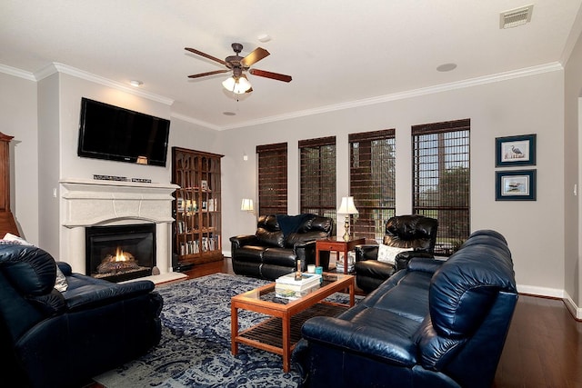 70 N Knights Crossing Dr, The Woodlands, TX 77382 - living room with wood finished floors, baseboards, a ceiling fan, a glass covered fireplace, and ornamental molding