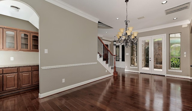 70 N Knights Crossing Dr, The Woodlands, TX 77382 - unfurnished dining area with ornamental molding, baseboards, dark wood finished floors, recessed lighting, and french doors
