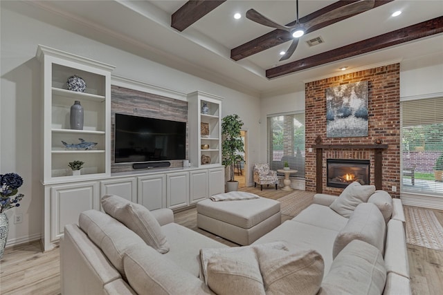 11 Hillsborough Dr E, Montgomery, TX 77356 - living room featuring light wood finished floors, beamed ceiling, ceiling fan, healthy amount of natural light, and recessed lighting