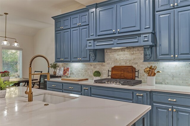 11 Hillsborough Dr E, Montgomery, TX 77356 - kitchen featuring blue cabinetry, stainless steel gas stovetop, light countertops, tasteful backsplash, and lofted ceiling