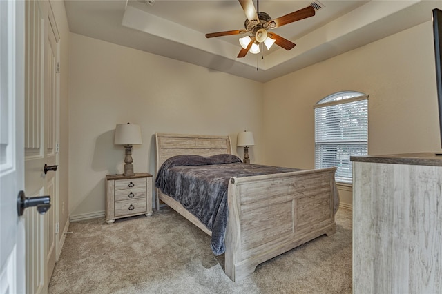 11 Hillsborough Dr E, Montgomery, TX 77356 - bedroom with light colored carpet, a tray ceiling, baseboards, and ceiling fan