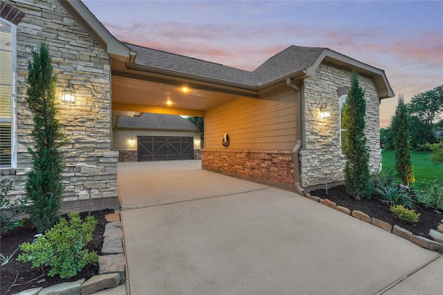 11 Hillsborough Dr E, Montgomery, TX 77356 - view of home's exterior featuring stone siding, driveway, brick siding, and a shingled roof
