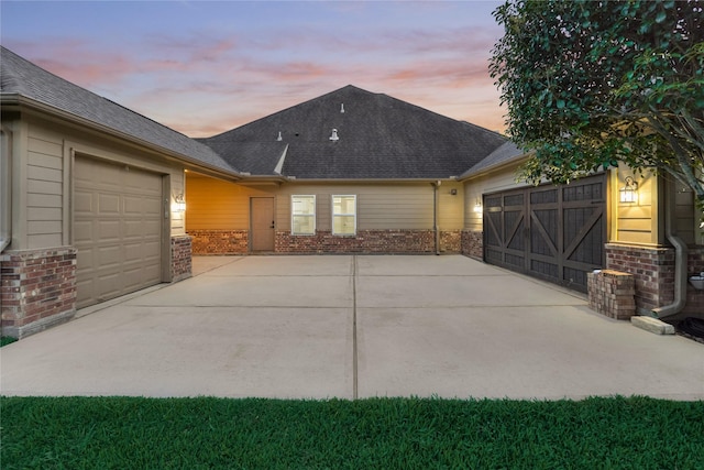 11 Hillsborough Dr E, Montgomery, TX 77356 - view of front facade with brick siding, a garage, concrete driveway, and roof with shingles