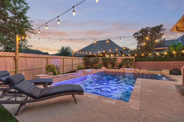 11 Hillsborough Dr E, Montgomery, TX 77356 - pool at dusk with a fenced backyard and a patio area