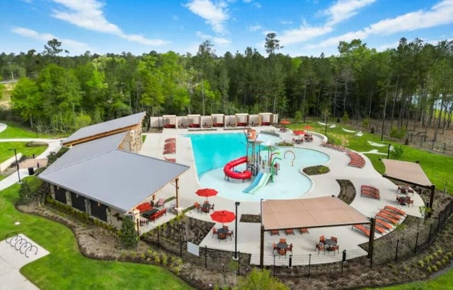 16142 Sapphire Crest Dr, Conroe, TX 77378 - community pool featuring a patio area and a view of trees