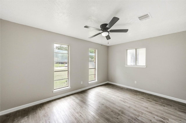 9627 Crooked Wood Ln, Houston, TX 77086 - unfurnished room featuring wood finished floors, baseboards, and a ceiling fan